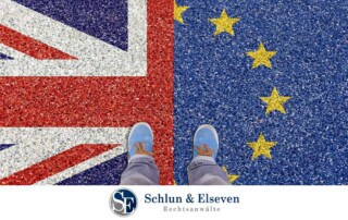Person standing on a painted image of a half-Union flag and half-EU flag. One foot on each side.
