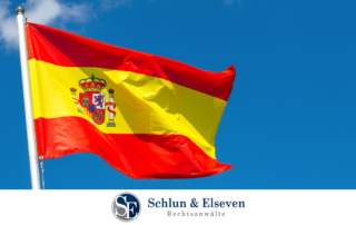 A Spanish flag with a blue sky in the background